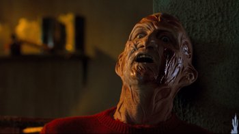 Movie still from “Freddy's Dead: The Final Nightmare” (1991), directed by Rachel Talalay – The face of a wax figure of freddy krueger; Close Up shot, Low angle