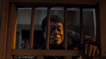 Movie still from “Freddy's Dead: The Final Nightmare” (1991), directed by Rachel Talalay – A man looking through bars of a wooden fence; Close Up shot, High angle