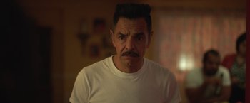 Movie still from “The Valet” (2022), directed by Richard Wong – A person wearing a white t - shirt; Close Up shot, Over the shoulder angle