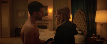 Movie still from “The Valet” (2022), directed by Richard Wong – A man and a woman standing next to each other in a room; Medium shot, Over the shoulder angle