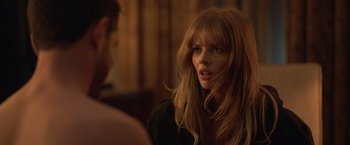 Movie still from “The Valet” (2022), directed by Richard Wong – A woman with long red hair is looking at the camera; Close Up shot, Over the shoulder angle