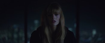 Movie still from “The Valet” (2022), directed by Richard Wong – A woman with long blonde hair is in the dark; Close Up shot, Low angle