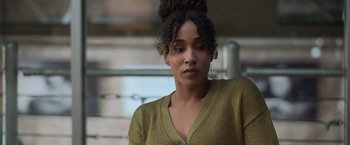 Movie still from “The Valet” (2022), directed by Richard Wong – A person wearing a sweater; Close Up shot, Over the shoulder angle