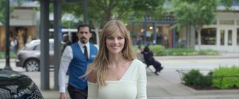 Movie still from “The Valet” (2022), directed by Richard Wong – A woman in a white dress standing next to a man; Medium shot, Over the shoulder angle