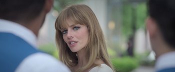 Movie still from “The Valet” (2022), directed by Richard Wong – A person with long blonde hair; Close Up shot, Over the shoulder angle