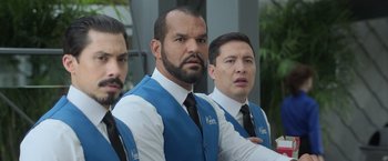 Movie still from “The Valet” (2022), directed by Richard Wong – A group of men standing next to each other wearing ties; Close Up shot, Over the shoulder angle