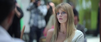 Movie still from “The Valet” (2022), directed by Richard Wong – A woman with long blonde hair and blue eyes; Close Up shot, Low angle