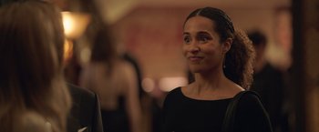 Movie still from “The Valet” (2022), directed by Richard Wong – A person wearing a black dress; Close Up shot, Over the shoulder angle