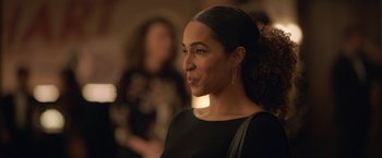 Movie still from “The Valet” (2022), directed by Richard Wong – A person wearing a black dress; Close Up shot, Over the shoulder angle