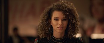 Movie still from “The Valet” (2022), directed by Richard Wong – A person with curly brown hair; Close Up shot, Over the shoulder angle