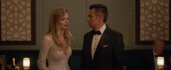 Movie still from “The Valet” (2022), directed by Richard Wong – A man and a woman standing next to each other; Medium shot, Over the shoulder angle