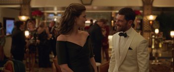 Movie still from “The Valet” (2022), directed by Richard Wong – A man and a woman are talking to each other at an event; Medium shot, Over the shoulder angle