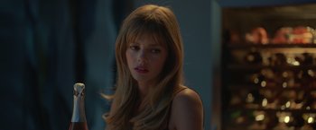 Movie still from “The Valet” (2022), directed by Richard Wong – A beautiful young woman with long , blonde hair; Close Up shot, Over the shoulder angle