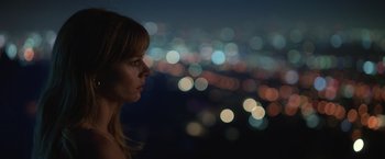Movie still from “The Valet” (2022), directed by Richard Wong – A woman is looking at the city lights at night; Close Up shot, Low angle