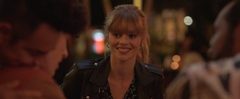 Movie still from “The Valet” (2022), directed by Richard Wong – A person wearing a leather jacket; Close Up shot, Over the shoulder angle