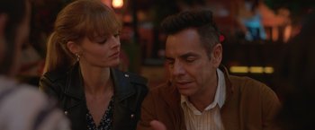 Movie still from “The Valet” (2022), directed by Richard Wong – A man and a woman sitting next to each other at a table; Close Up shot, Over the shoulder angle