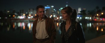 Movie still from “The Valet” (2022), directed by Richard Wong – A man and a woman standing next to each other; Medium shot, Over the shoulder angle