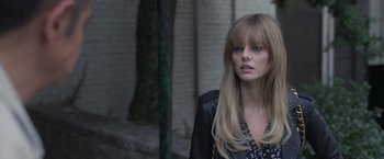Movie still from “The Valet” (2022), directed by Richard Wong – A beautiful young lady with long blonde hair and bangs; Close Up shot, Over the shoulder angle