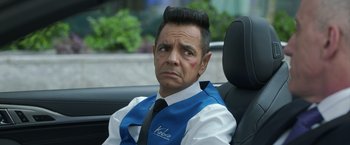 Movie still from “The Valet” (2022), directed by Richard Wong – A man sitting in the back seat of a car; Close Up shot, Over the shoulder angle