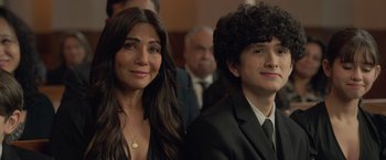 Movie still from “The Valet” (2022), directed by Richard Wong – A woman standing next to a man in a suit and tie; Close Up shot, Over the shoulder angle