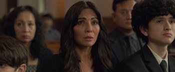 Movie still from “The Valet” (2022), directed by Richard Wong – A person with long black hair; Close Up shot, Over the shoulder angle