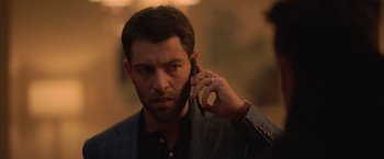 Movie still from “The Valet” (2022), directed by Richard Wong – A person talking on a cell phone; Close Up shot, Over the shoulder angle