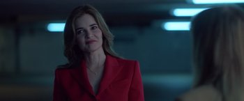 Movie still from “The Valet” (2022), directed by Richard Wong – A woman in a red jacket is smiling; Medium shot, Over the shoulder angle