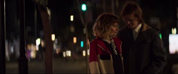 Movie still from “French Exit” (2020), directed by Azazel Jacobs – A woman in a red and black jacket standing next to a man; Medium shot, Over the shoulder angle