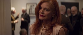 Movie still from “French Exit” (2020), directed by Azazel Jacobs – An older woman with red hair wearing a pink dress; Close Up shot, Low angle