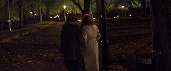 Movie still from “French Exit” (2020), directed by Azazel Jacobs – Two women are walking in a park at night; Wide shot, Over the shoulder angle