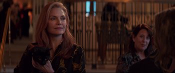 Movie still from “French Exit” (2020), directed by Azazel Jacobs – A woman with long red hair standing in front of a gate; Close Up shot, Over the shoulder angle