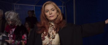 Movie still from “French Exit” (2020), directed by Azazel Jacobs – A woman with long red hair wearing a black jacket; Close Up shot, Low angle