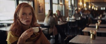 Movie still from “French Exit” (2020), directed by Azazel Jacobs – A woman drinking a cup of coffee in a restaurant; Close Up shot, Over the shoulder angle