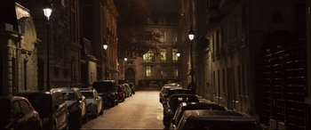 Movie still from “French Exit” (2020), directed by Azazel Jacobs – A street with parked cars on both sides of the street; Extreme Wide shot, High angle