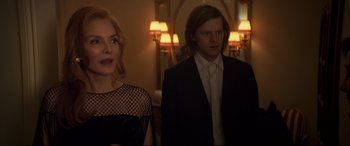 Movie still from “French Exit” (2020), directed by Azazel Jacobs – A man and a woman standing next to each other in front of a mirror; Medium shot, Over the shoulder angle