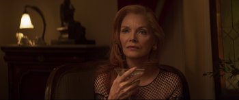 Movie still from “French Exit” (2020), directed by Azazel Jacobs – A woman holding a martini glass in her hand; Close Up shot, Over the shoulder angle