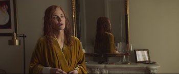 Movie still from “French Exit” (2020), directed by Azazel Jacobs – A woman is standing in front of a bathroom mirror; Medium shot, Over the shoulder angle