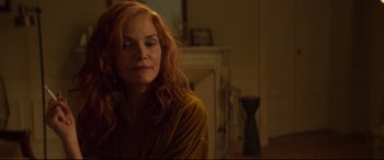 Movie still from “French Exit” (2020), directed by Azazel Jacobs – A woman with red hair sitting in a living room; Close Up shot, Over the shoulder angle