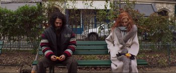 Movie still from “French Exit” (2020), directed by Azazel Jacobs – A man and a woman sitting on a park bench; Medium shot, Low angle