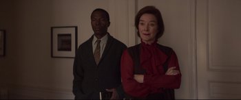 Movie still from “French Exit” (2020), directed by Azazel Jacobs – A man and a woman standing next to each other; Medium shot, Low angle