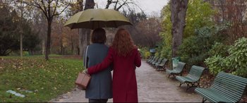 Movie still from “French Exit” (2020), directed by Azazel Jacobs – Two women walking down a path under an umbrella; Wide shot, High angle