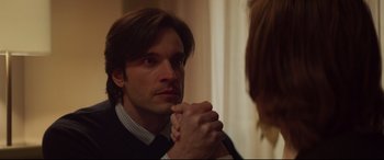 Movie still from “French Exit” (2020), directed by Azazel Jacobs – A man holding a woman's hand in front of a bathroom mirror; Close Up shot, Over the shoulder angle