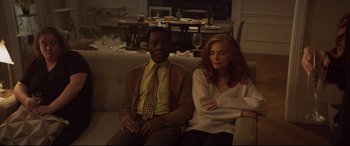 Movie still from “French Exit” (2020), directed by Azazel Jacobs – A man and a woman sitting on a couch in a living room; Medium shot, High angle