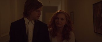 Movie still from “French Exit” (2020), directed by Azazel Jacobs – A man and a woman standing next to each other in a room; Close Up shot, Over the shoulder angle