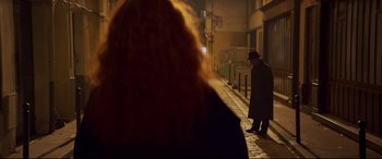 Movie still from “French Exit” (2020), directed by Azazel Jacobs – A man in a hat is walking down the street; Medium shot, Over the shoulder angle