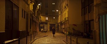 Movie still from “French Exit” (2020), directed by Azazel Jacobs – A woman walking down a street at night in the dark; Extreme Wide shot, High angle