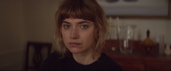 Movie still from “French Exit” (2020), directed by Azazel Jacobs – A person wearing a black t - shirt; Close Up shot, Over the shoulder angle