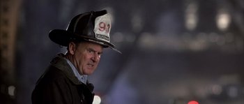 Movie still from “Frequency” (2000), directed by Gregory Hoblit – A man wearing a fireman's hat and a jacket; Close Up shot, Low angle