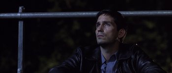 Movie still from “Frequency” (2000), directed by Gregory Hoblit – A person wearing a leather jacket; Close Up shot, Over the shoulder angle