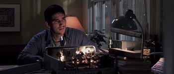 Movie still from “Frequency” (2000), directed by Gregory Hoblit – A man sitting in front of a bunch of lit candles; Close Up shot, Low angle